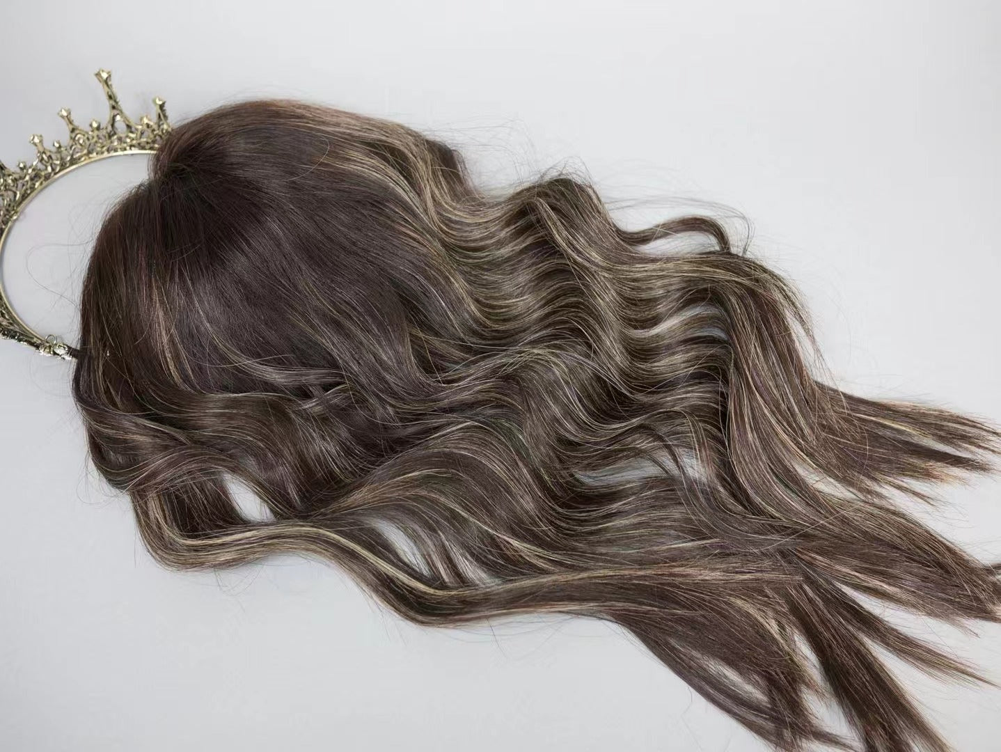 ERIN brown with blonde highlights fully wefted topper styled with waves