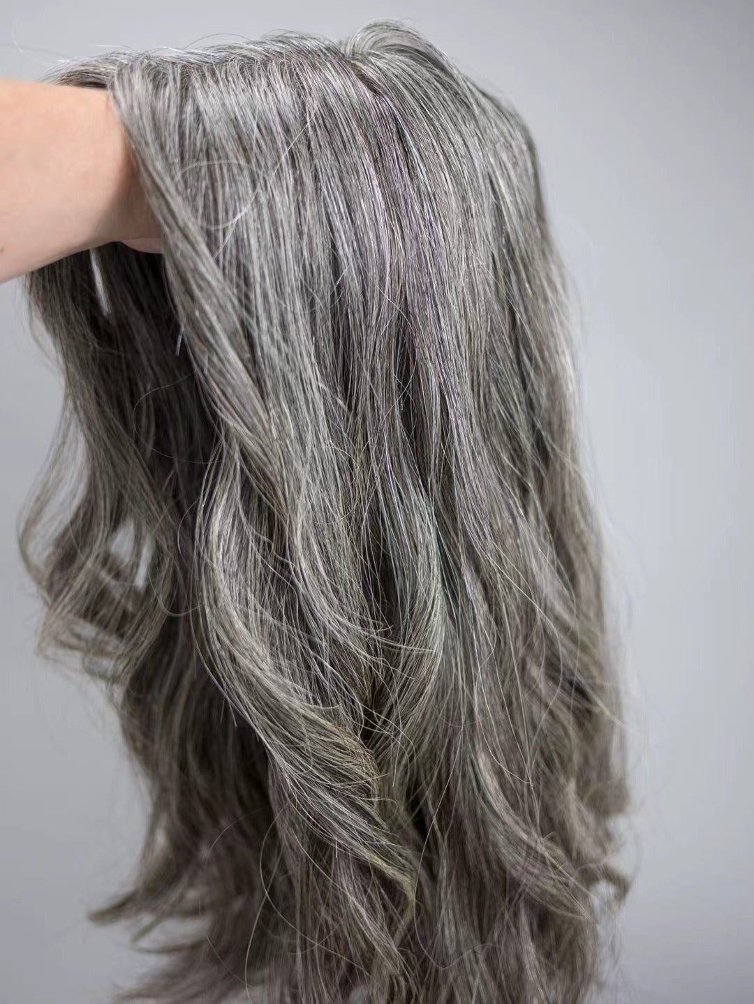 JOAN medium salt and pepper gray blend topper styled with waves